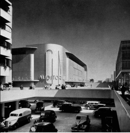 A black and white photo of a scale model of a futuristic city's intersection. The creator's idea of future technology on a city-wide scale, shown at the 1939 New York World's Fair. Sidewalks and pedestrian crossing are above the streets, which have been recessed below the rest of the city to separate them from pedestrian traffic